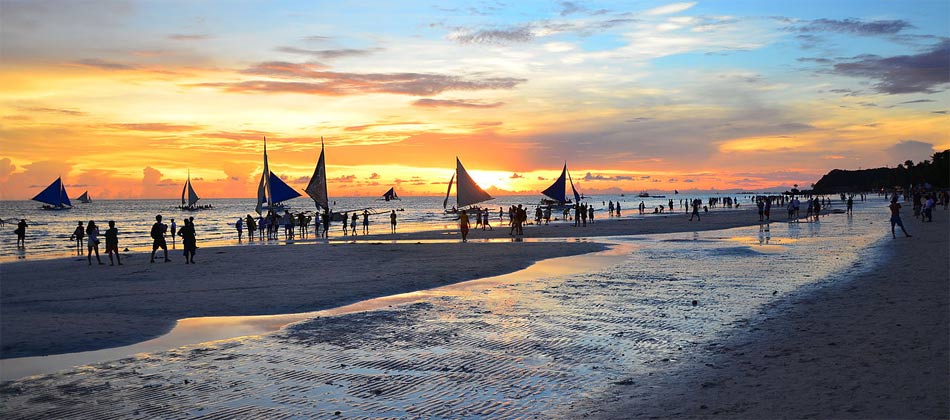 Sailing a Paraw at sunset is a popular tourist activity in Boracay